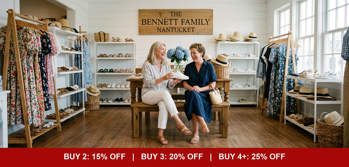 Women laughing while shopping for shoes and dresses in The Bennett Family boutique